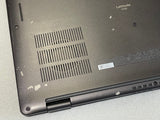 Back view of a laptop with 'Latitude' branding on a light gray surface